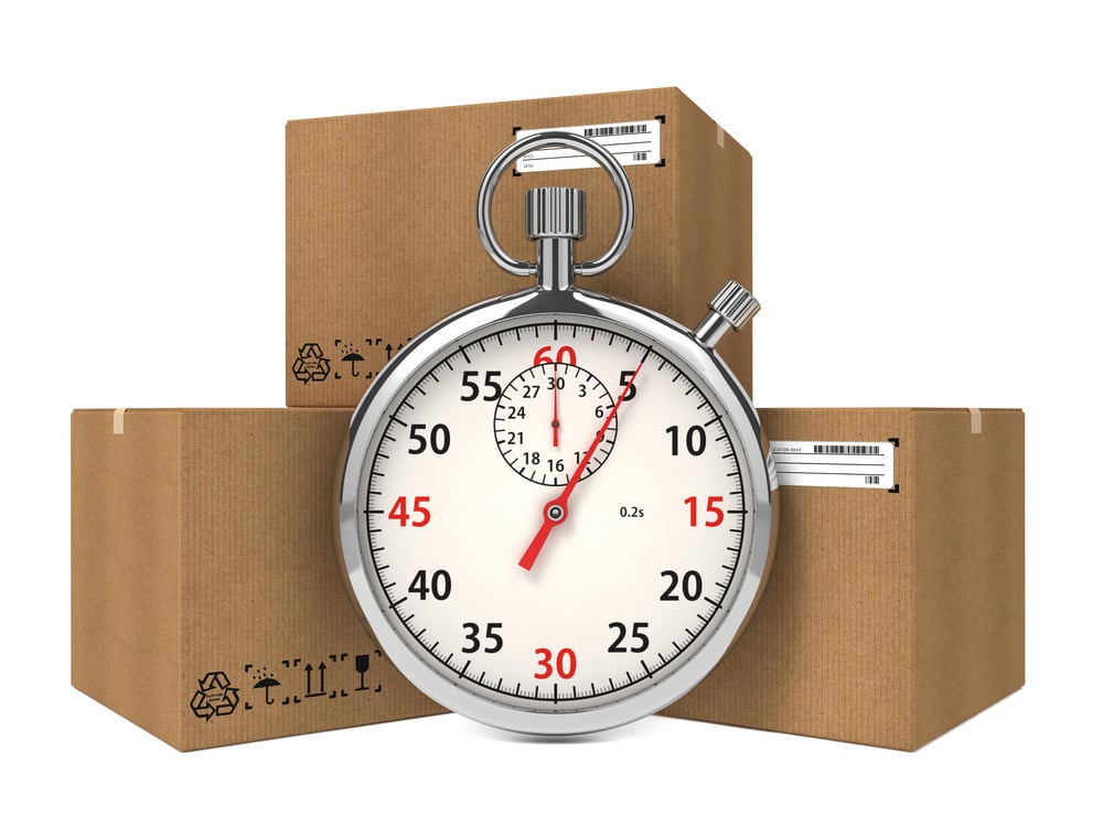 Stopwatch Over a Carton Boxes. Express Delivery Concept.